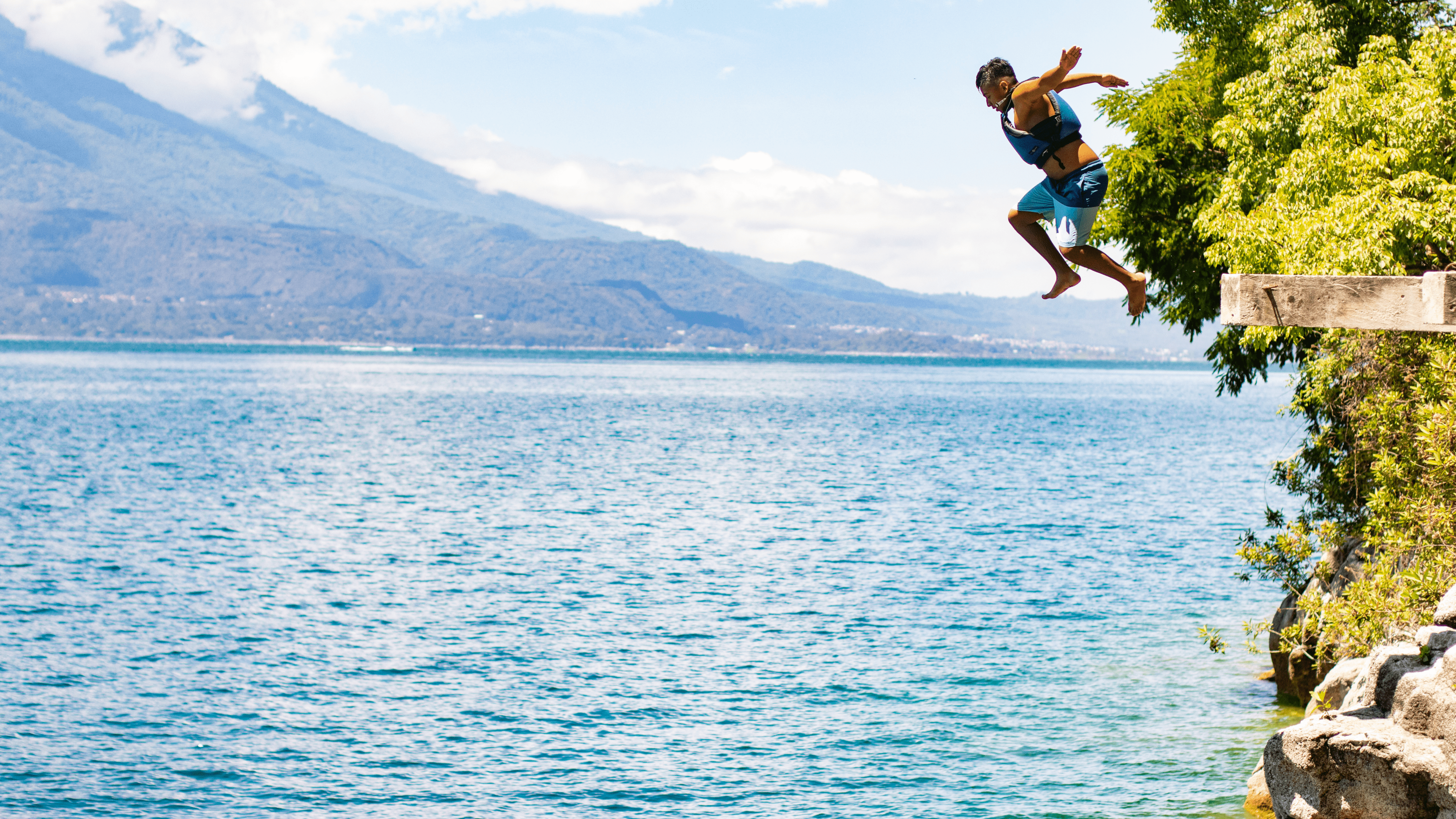 Man jumps from a two metre cliffside in Lake Atitlan.