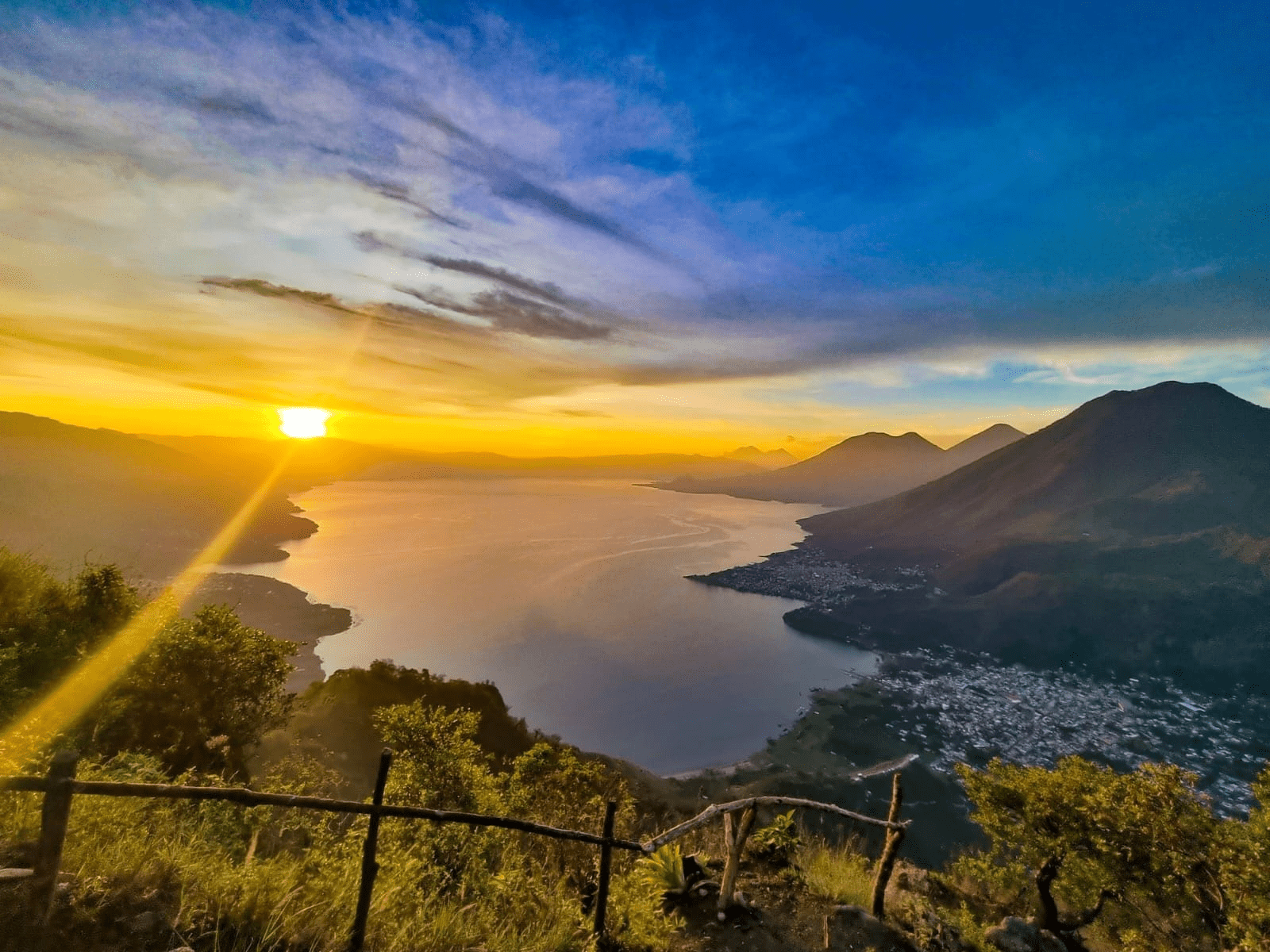 Sun rising over the volcanoes behind Lake Atitlan
