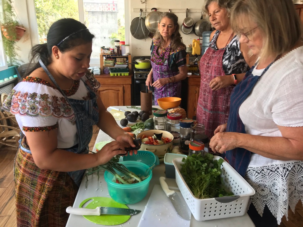 A Mayan chef showing tourists how to prepare the Guatemalan dish.