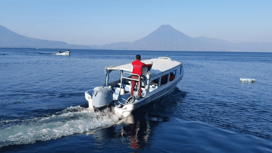 A lancha, the local public transportation, crossing lake atitlan.