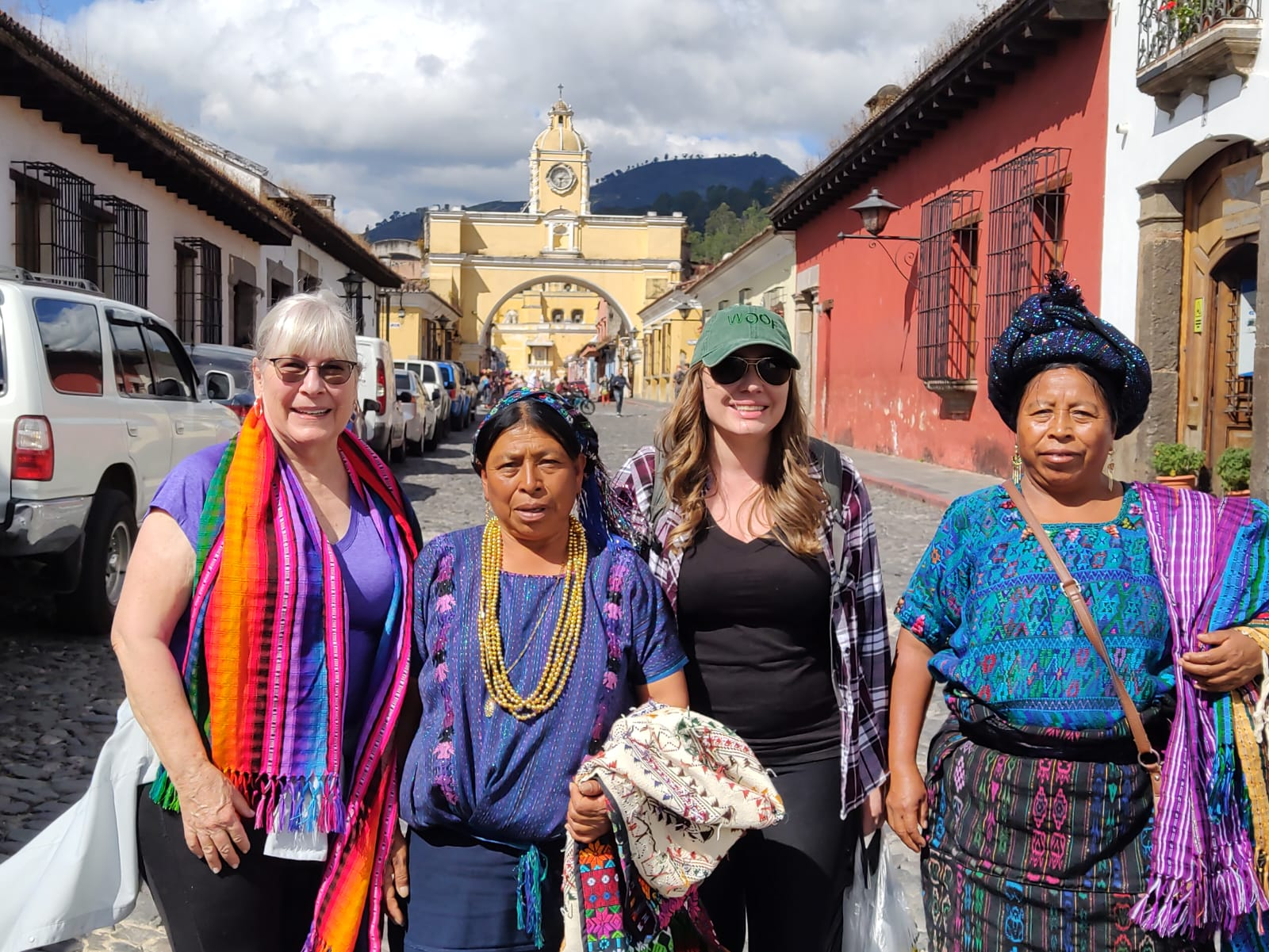 Local women sharing their traditional clothing with visitors.