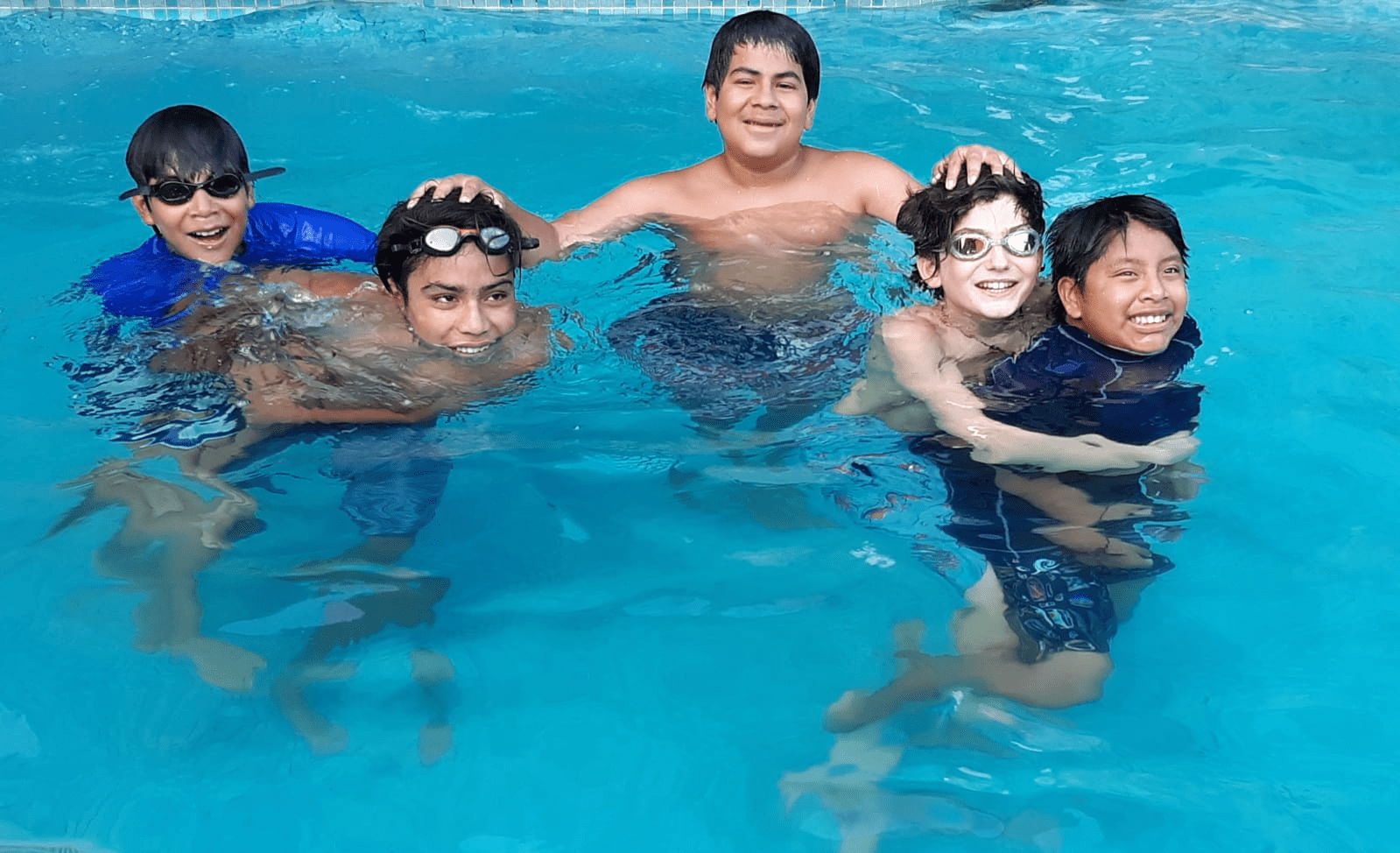Children having fun in a swimming pool.