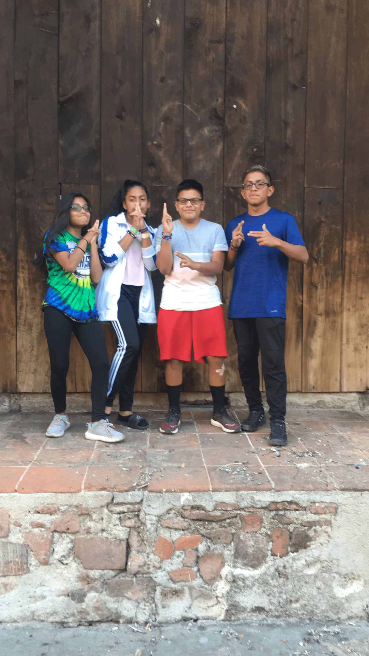 Teens posing in front of a church door.
