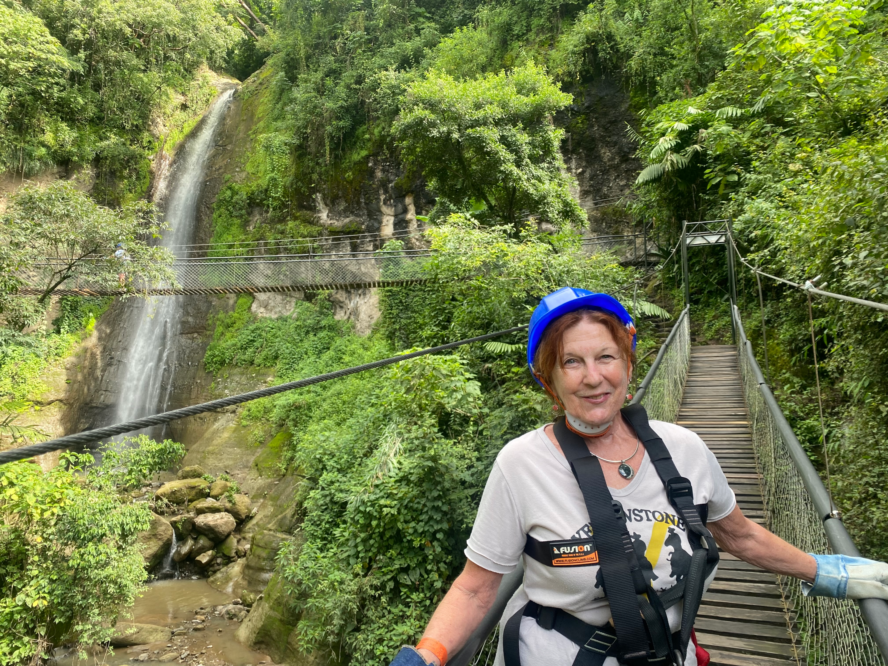 Suspension bridge at the nature reserve with close up view of a waterfall.